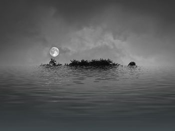 Scenic view of moon in water against sky