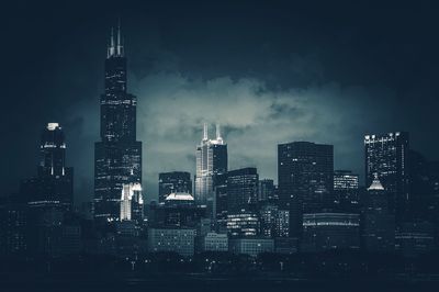 View of skyscrapers lit up at night