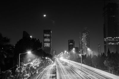 Illuminated city street at night