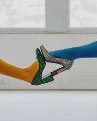 Women feet in glitter shoes