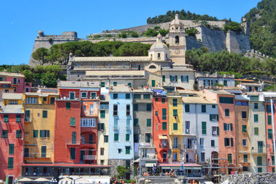 Buildings in city against clear sky