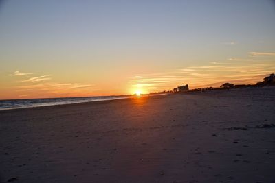 Scenic view of beach against sky during sunset