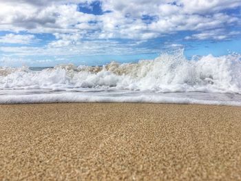 Surface level of beach against sky