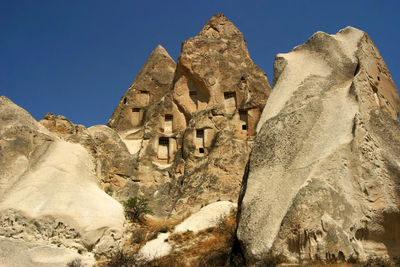 Low angle view of rock formation against sky