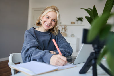 Portrait of young woman reading book