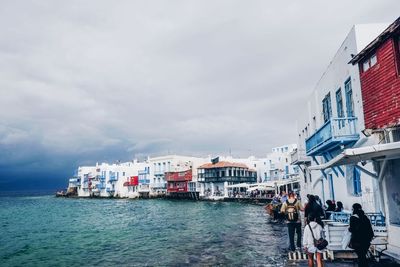 Buildings against cloudy sky