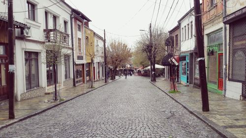 Street amidst buildings in city against sky