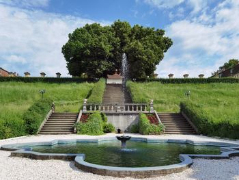 Fountain in park against sky