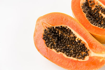 Close-up of orange fruit against white background