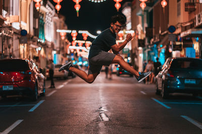 Man jumping on street at night