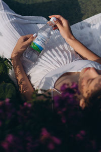 Midsection of woman holding umbrella against plants