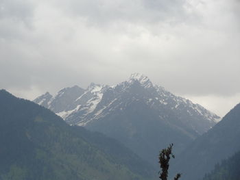 Scenic view of mountains against sky during winter