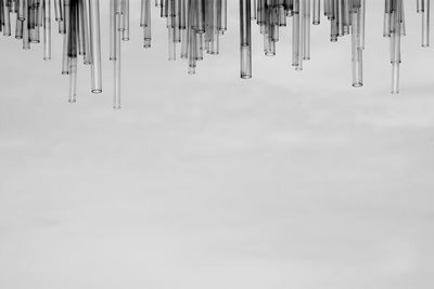 Close-up of empty hanging over water against sky