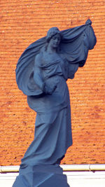 Low angle view of statue against wall