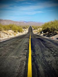 Empty road against sky