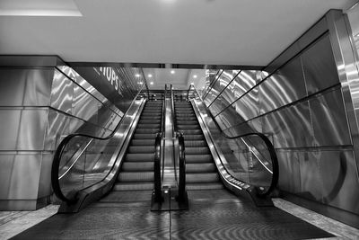 Empty illuminated escalators in modern building