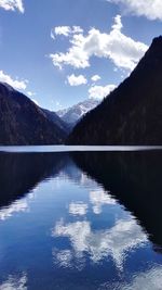 Scenic view of calm lake against mountain range