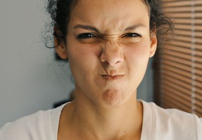 Close-up portrait of woman making a face