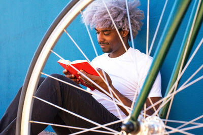 Close-up of man looking at camera while sitting outdoors