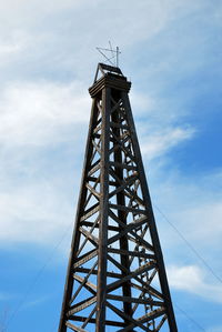 Low angle view of communications tower against sky