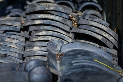 Full frame shot of black equipment stacked outdoors