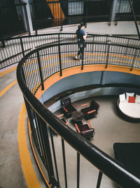 High angle view of woman walking on railing