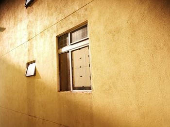 Low angle view of window on wall of building