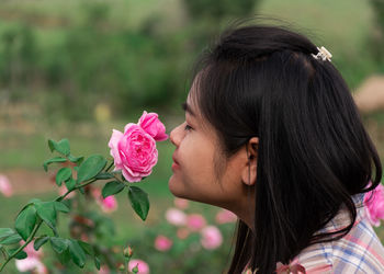 Portrait of woman with pink roses