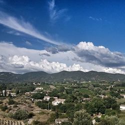 Scenic view of mountain range against cloudy sky