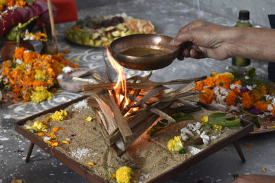 Midsection of person preparing food on barbecue grill