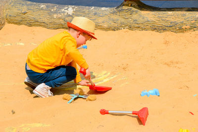 Boy and girl playing on the beach on summer holidays. children building a sandcastle at the sea.