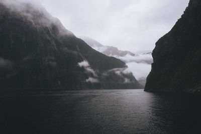 Scenic view of mountains at milford sound during foggy weather, nz