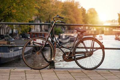 Bicycle parked by railing in river