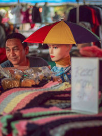 People sitting at market stall