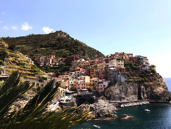 Aerial view of town by sea against sky