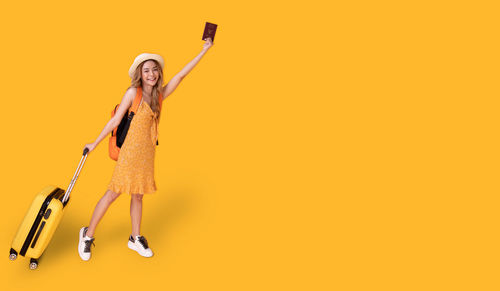 Portrait of a woman holding yellow background