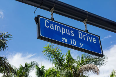 Low angle view of road sign against sky