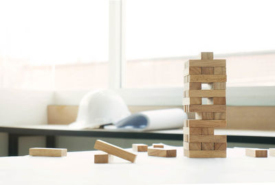 Stack of wooden blocks on table at home