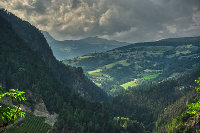 Sunset over the mountains in trentino alto adige with vineyards and orchards