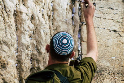 Rear view of man standing on rock