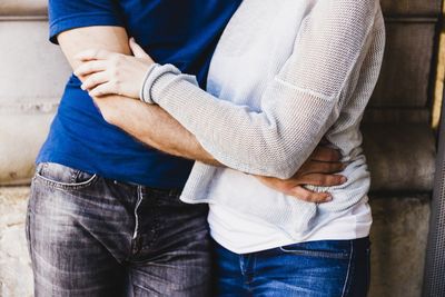 Midsection of couple standing outdoors