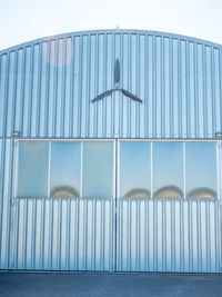 Carbon propellers on metal sheet hall wall at airport. three blade propeller for ultralight planes