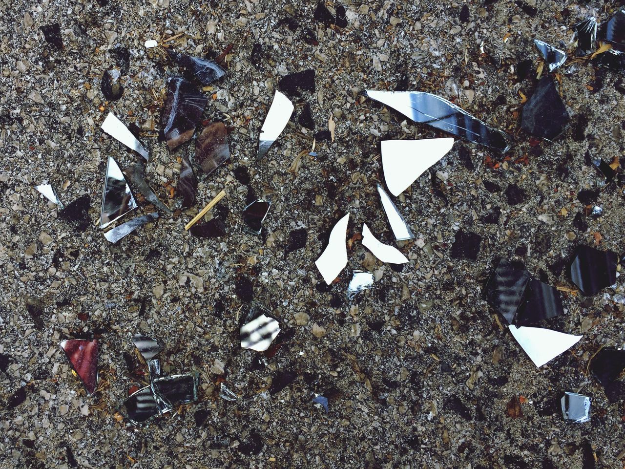 high angle view, sand, transportation, damaged, group of objects, asphalt, overhead view, broken, outdoors, messy, obsolete, fragility, day, tranquility, nature, medium group of objects