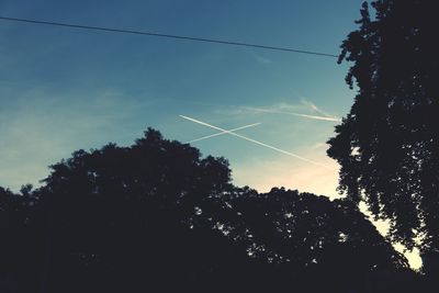 Low angle view of power lines against sky