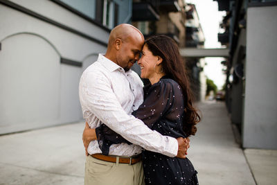 Midsection of couple standing on floor in city