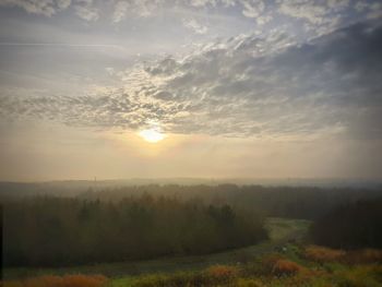 Scenic view of field against sky during sunset