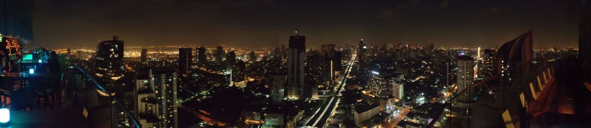 Panoramic view of city lit up at night