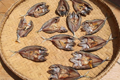 High angle view of dried fish on wicker plate