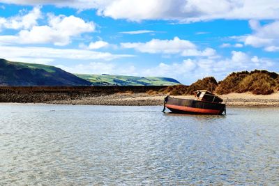 Boat on river against sky