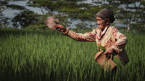 Side view of woman standing on field